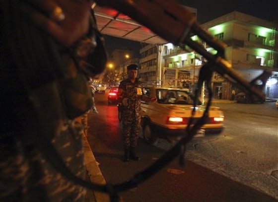 Iraqi policemen stand guard at a check point in Baghdad, Iraq, Tuesday. Iraqi Prime Minister Nouri al-Maliki said the end of American combat operations Tuesday leaves his country independent and an equal to the United States and he assured his people their own security forces will protect them.